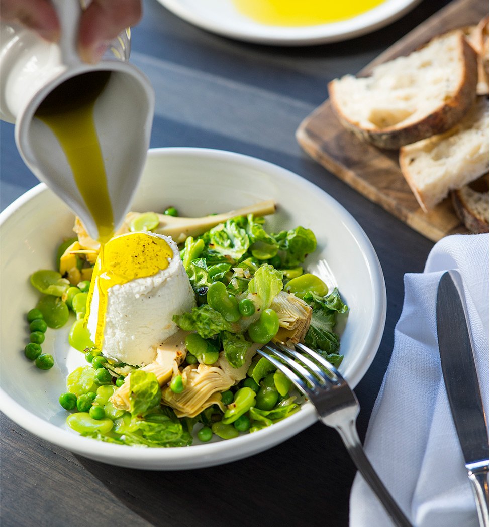 Ricotta with oil poured on broad beans